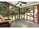 Screened porch with wicker seating, ceiling fan, and view of the backyard at 4915 Galax Dr, Charlotte, NC 28213