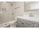 Bathroom featuring a toilet, sink, vanity, and tiled shower and walls at 507 E Cloninger St, Dallas, NC 28034