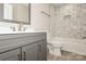 Stylish bathroom with a sleek vanity, modern fixtures, and a tiled shower-tub combination at 507 E Cloninger St, Dallas, NC 28034