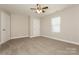 Comfortable carpeted bedroom featuring a ceiling fan, window and two doors, creating a cozy atmosphere at 507 E Cloninger St, Dallas, NC 28034