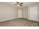 Bedroom with neutral carpeting, trim and ceiling fan, with two paneled doors providing access and style at 507 E Cloninger St, Dallas, NC 28034