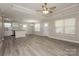 Open concept living space with wood flooring and natural light, flowing into the kitchen at 507 E Cloninger St, Dallas, NC 28034