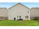 The backyard has a grill, patio furniture, level green grass, and is fenced in at 507 Galesburg Dr, Monroe, NC 28110