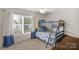 Charming bedroom features a bunk bed with blue bedding and a large window at 507 Galesburg Dr, Monroe, NC 28110