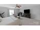 Bright bedroom featuring a desk, exercise equipment, large television, and sitting area at 507 Galesburg Dr, Monroe, NC 28110