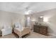Adorable bedroom features a canopy bed with pink accents, a ceiling fan, and dresser at 507 Galesburg Dr, Monroe, NC 28110