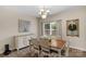 Well-lit dining room with hardwood floors and a decorative chandelier hanging above the table at 507 Galesburg Dr, Monroe, NC 28110