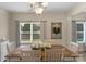 Charming dining room with hardwood table, seating for six, chandelier, and plenty of natural light at 507 Galesburg Dr, Monroe, NC 28110
