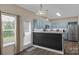 Cozy kitchen features blue cabinets, stainless steel appliances, light countertops and a door leading to the outside at 507 Galesburg Dr, Monroe, NC 28110