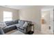 Comfortable living room boasts a gray sectional sofa, neutral walls and carpet at 507 Galesburg Dr, Monroe, NC 28110