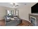 Bright living room with hardwood floors, a leather sectional sofa and a fireplace at 507 Galesburg Dr, Monroe, NC 28110