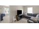 Cozy living room features a comfortable gray sectional and a modern entertainment center at 507 Galesburg Dr, Monroe, NC 28110