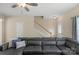 Cozy living room featuring hardwood floors, a leather sectional sofa and a stairway to the second floor at 507 Galesburg Dr, Monroe, NC 28110