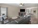 Inviting living room featuring a fireplace, ceiling fan and a comfortable leather sectional sofa at 507 Galesburg Dr, Monroe, NC 28110