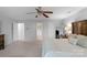 Spacious bedroom with neutral carpet and walls, well lit with ceiling fan and large mirror at 507 Galesburg Dr, Monroe, NC 28110