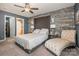 Spacious bedroom with decorative wood accent wall and a view into the en-suite bathroom at 5402 Harris Cove Dr, Charlotte, NC 28269