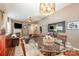 Open-concept dining area features modern lighting and hardwood floors adjacent to the living room at 5402 Harris Cove Dr, Charlotte, NC 28269