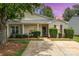 Charming single-story home features a welcoming front porch, manicured landscaping, and a well-maintained lawn at 5402 Harris Cove Dr, Charlotte, NC 28269