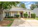 Charming single-story home features a welcoming front porch, manicured landscaping, and a well-maintained lawn at 5402 Harris Cove Dr, Charlotte, NC 28269