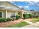 Inviting single-story home with a cozy front porch, manicured shrubs, and well-maintained landscaping at 5402 Harris Cove Dr, Charlotte, NC 28269
