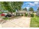 Charming one-story home showcasing a well-kept lawn, mature trees, and an extended driveway with ample parking at 5402 Harris Cove Dr, Charlotte, NC 28269
