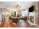 Inviting living room features hardwood floors, a fireplace, stylish furniture, and abundant natural light at 5402 Harris Cove Dr, Charlotte, NC 28269