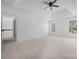 Spacious bedroom with tray ceiling, ceiling fan, neutral carpet, and natural light at 6504 Sybil Ct, Indian Trail, NC 28079