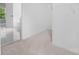 Spacious walk-in closet next to the bathroom, featuring carpet flooring and open shelving at 6504 Sybil Ct, Indian Trail, NC 28079