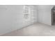 Walk-in closet featuring built-in white shelving with a window for natural light at 6504 Sybil Ct, Indian Trail, NC 28079