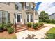 Inviting front entrance with brick steps, decorative shrubs and flowerbeds accenting a charming home exterior at 6504 Sybil Ct, Indian Trail, NC 28079