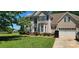 Charming two-story home with a manicured lawn, lush landscaping, and a classic facade at 6504 Sybil Ct, Indian Trail, NC 28079
