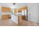 Well-lit kitchen featuring an island, stainless steel appliances, and wood cabinets at 6504 Sybil Ct, Indian Trail, NC 28079