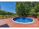 Outdoor pool area with wooden deck and peaceful lake views at 6504 Sybil Ct, Indian Trail, NC 28079
