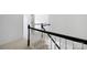 Carpeted staircase with white risers and black handrail at 6504 Sybil Ct, Indian Trail, NC 28079