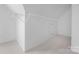 Walk-in closet featuring custom shelving and plush carpeting, providing ample storage space at 6504 Sybil Ct, Indian Trail, NC 28079