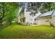 Home exterior featuring a patio, grill, backyard, and solar panels on the rear roof at 8014 Sherington Way, Charlotte, NC 28227