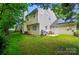 This home features a spacious yard, grilling area, solar panels, and patio seating, perfect for outdoor living at 8014 Sherington Way, Charlotte, NC 28227