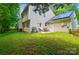 This home features a spacious yard, grilling area, solar panels, and patio seating, perfect for outdoor living at 8014 Sherington Way, Charlotte, NC 28227