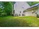 Outdoor living space with a spacious yard, grilling area, and patio seating perfect for gatherings and relaxation at 8014 Sherington Way, Charlotte, NC 28227