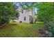 Landscaped backyard showcasing a well-maintained lawn, mature trees, and a classic fence for added privacy at 8014 Sherington Way, Charlotte, NC 28227