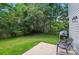 Private backyard with lush greenery, a patio, and space for outdoor seating at 8014 Sherington Way, Charlotte, NC 28227