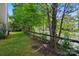 This backyard features a lush lawn with a wooden fence, offering privacy and a serene connection to nature at 8014 Sherington Way, Charlotte, NC 28227