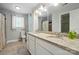 Bathroom featuring double sink vanity with granite countertop at 8014 Sherington Way, Charlotte, NC 28227
