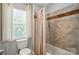 Cozy bathroom featuring a shower/tub combo and a window with a toilet at 8014 Sherington Way, Charlotte, NC 28227