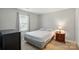 Bedroom featuring neutral walls and carpet, a window, and a dresser with nightstand at 8014 Sherington Way, Charlotte, NC 28227