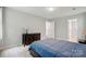 Bedroom featuring a bed with blue comforter and an ensuite bathroom at 8014 Sherington Way, Charlotte, NC 28227