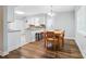 Bright dining area featuring modern accents and a view into the kitchen at 8014 Sherington Way, Charlotte, NC 28227