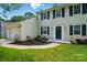 Well-maintained two-story home featuring a landscaped front yard and attached garage at 8014 Sherington Way, Charlotte, NC 28227