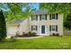 Charming two-story home featuring a well-manicured lawn and attached two-car garage at 8014 Sherington Way, Charlotte, NC 28227