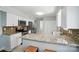 Bright kitchen boasts granite countertops, stainless appliances and mosaic tile backsplash at 8014 Sherington Way, Charlotte, NC 28227